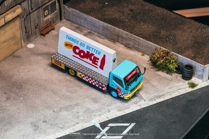 Model truck with Coca-Cola advertisement on a small outdoor area