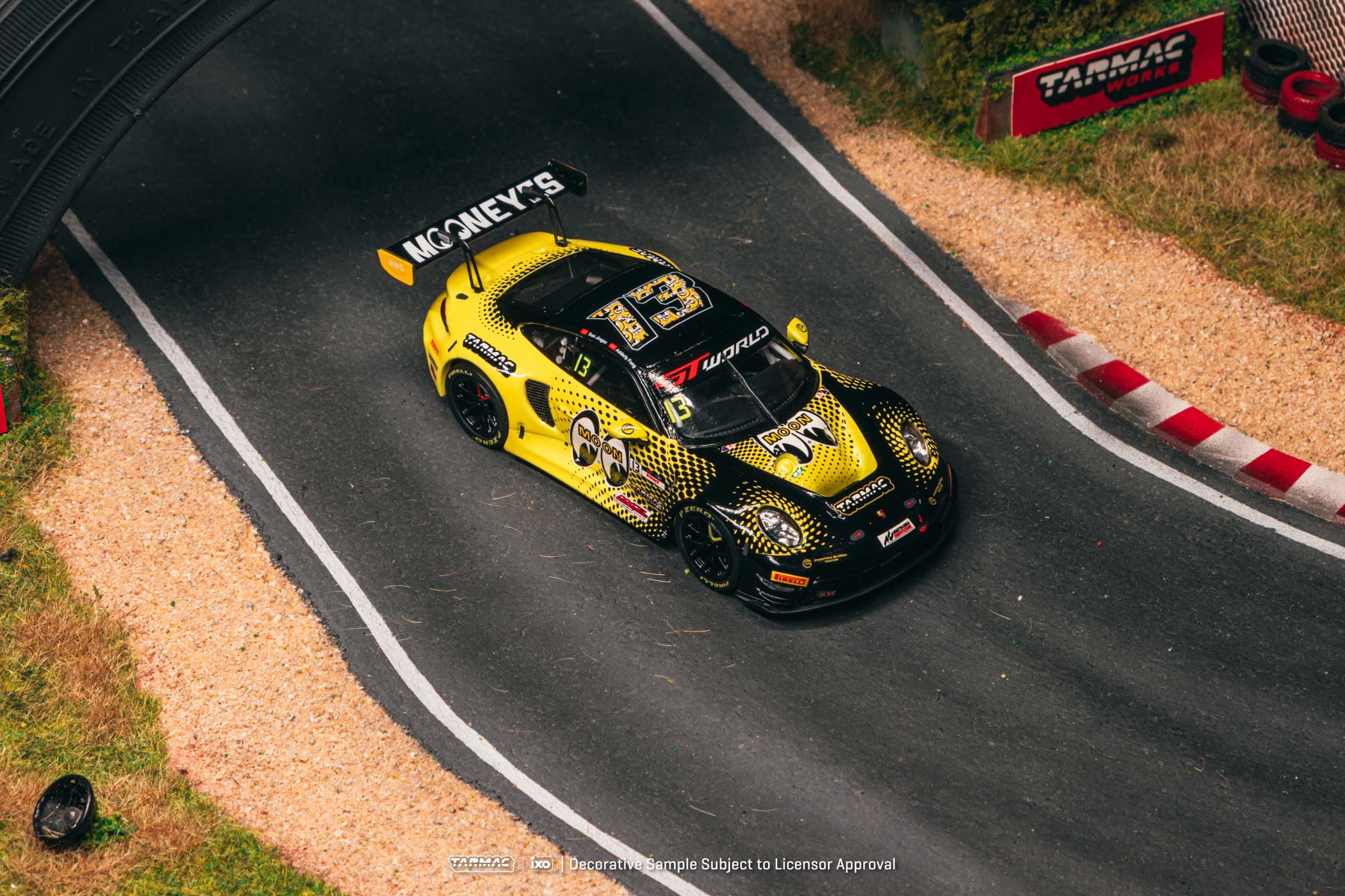Yellow race car on a track with visible branding