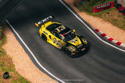 Yellow race car on a track with visible branding