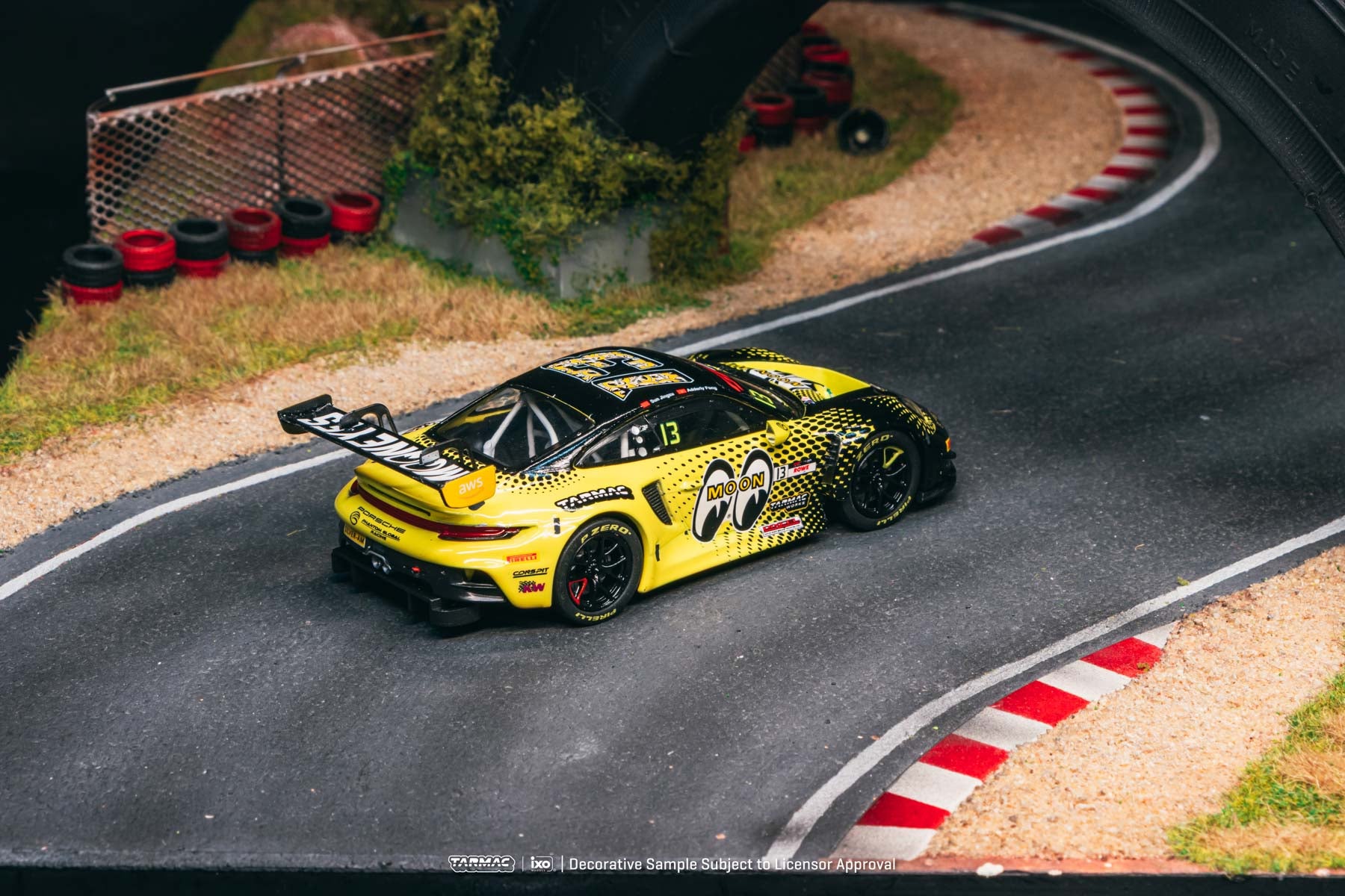 Yellow race car with black accents on a track