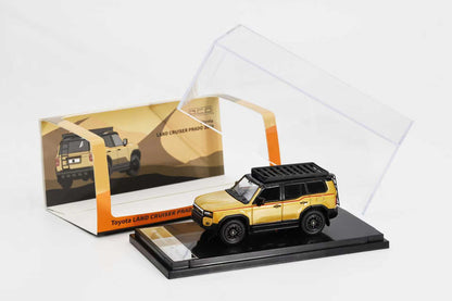 Model toy car of Toyota Land Cruiser Prado in front of its packaging box on a white background