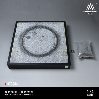 Model of a circular object on a gray surface with 'MOREART' branding.