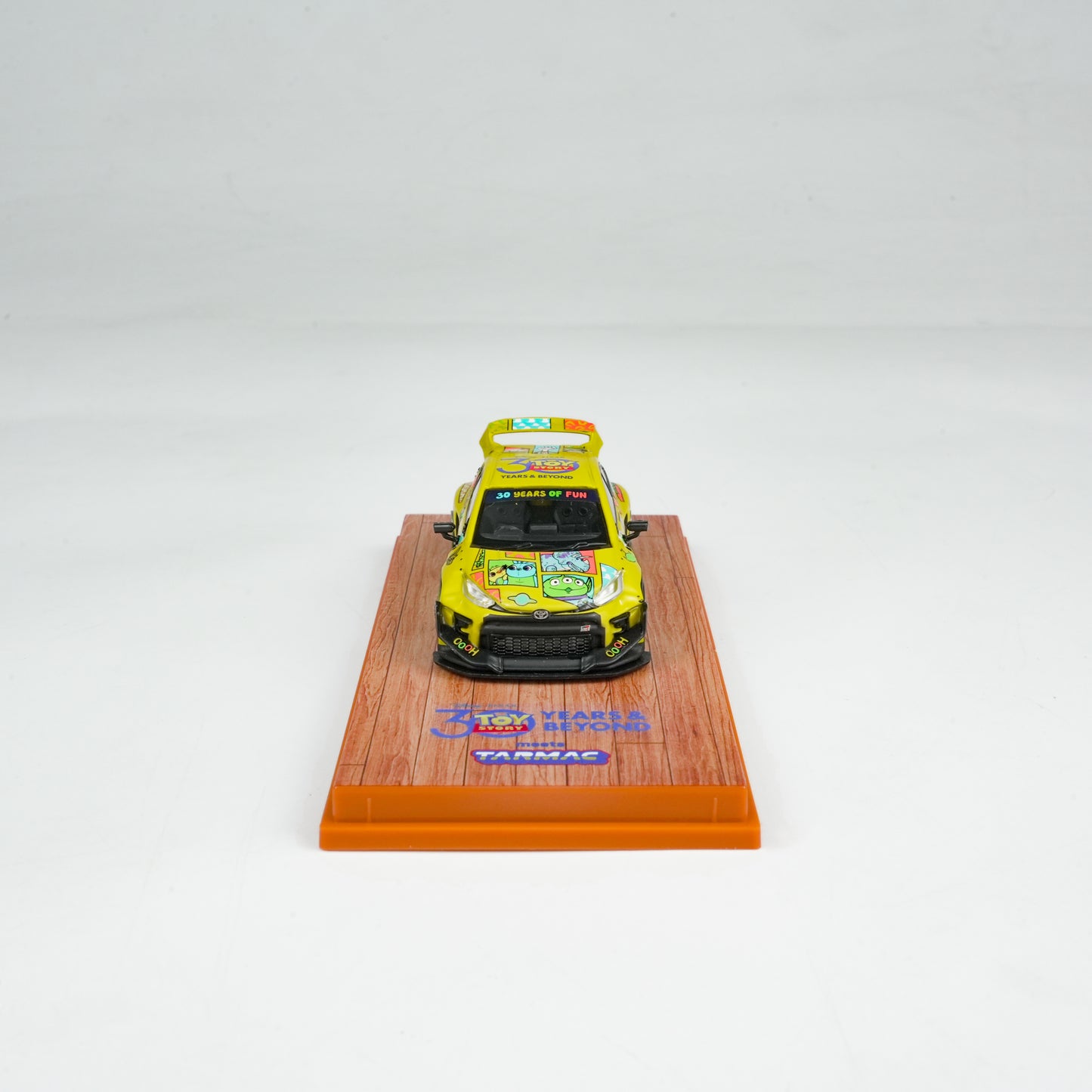 Model car on a wooden display stand with a white background