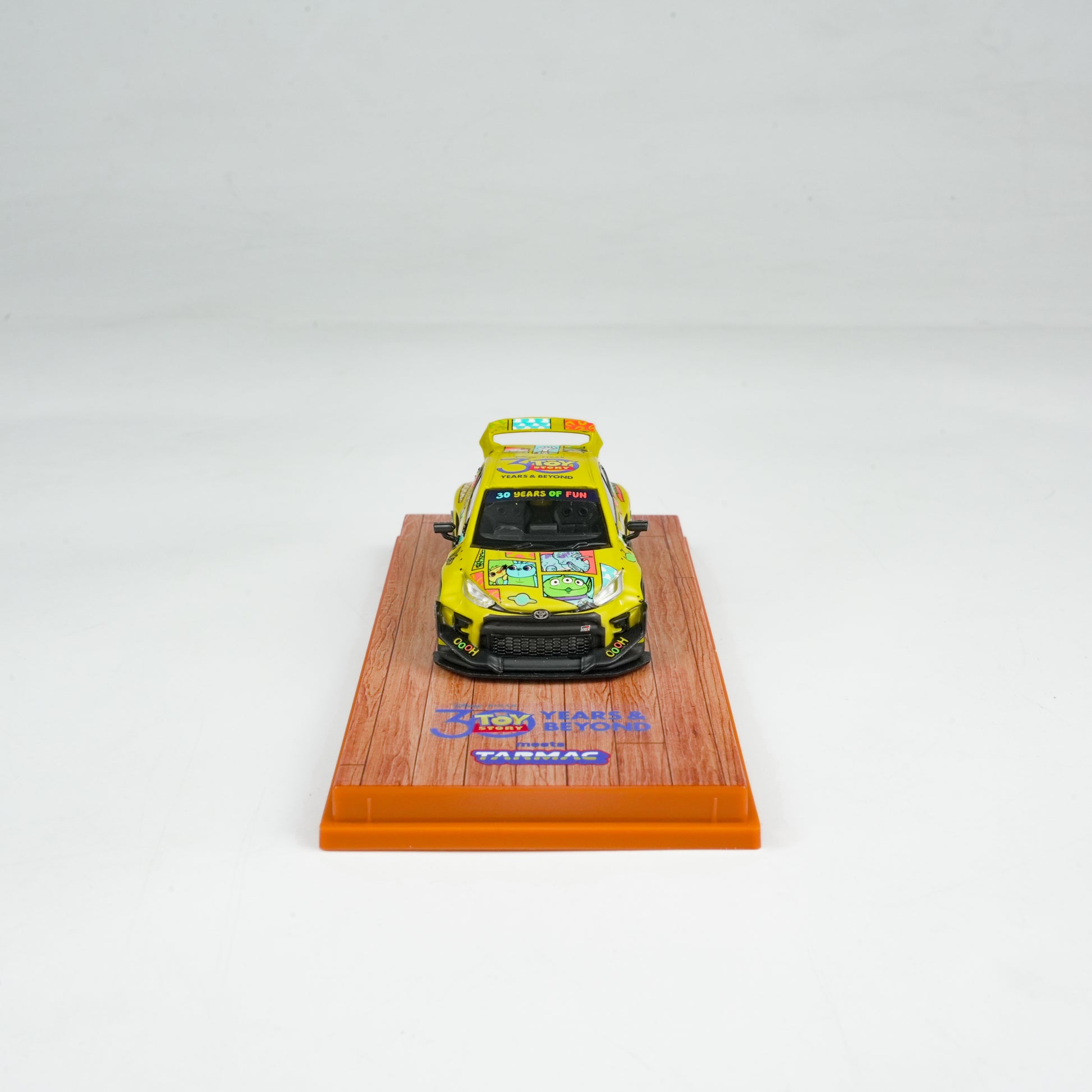 Model car on a wooden display stand with a white background