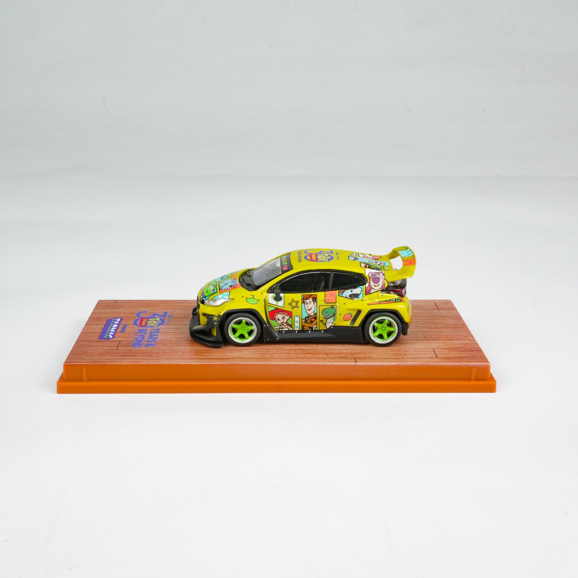 Colorful toy car on a display stand with a white background