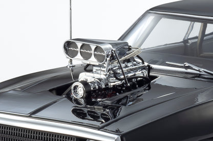 Close-up of a car engine with chrome details on a black car hood.