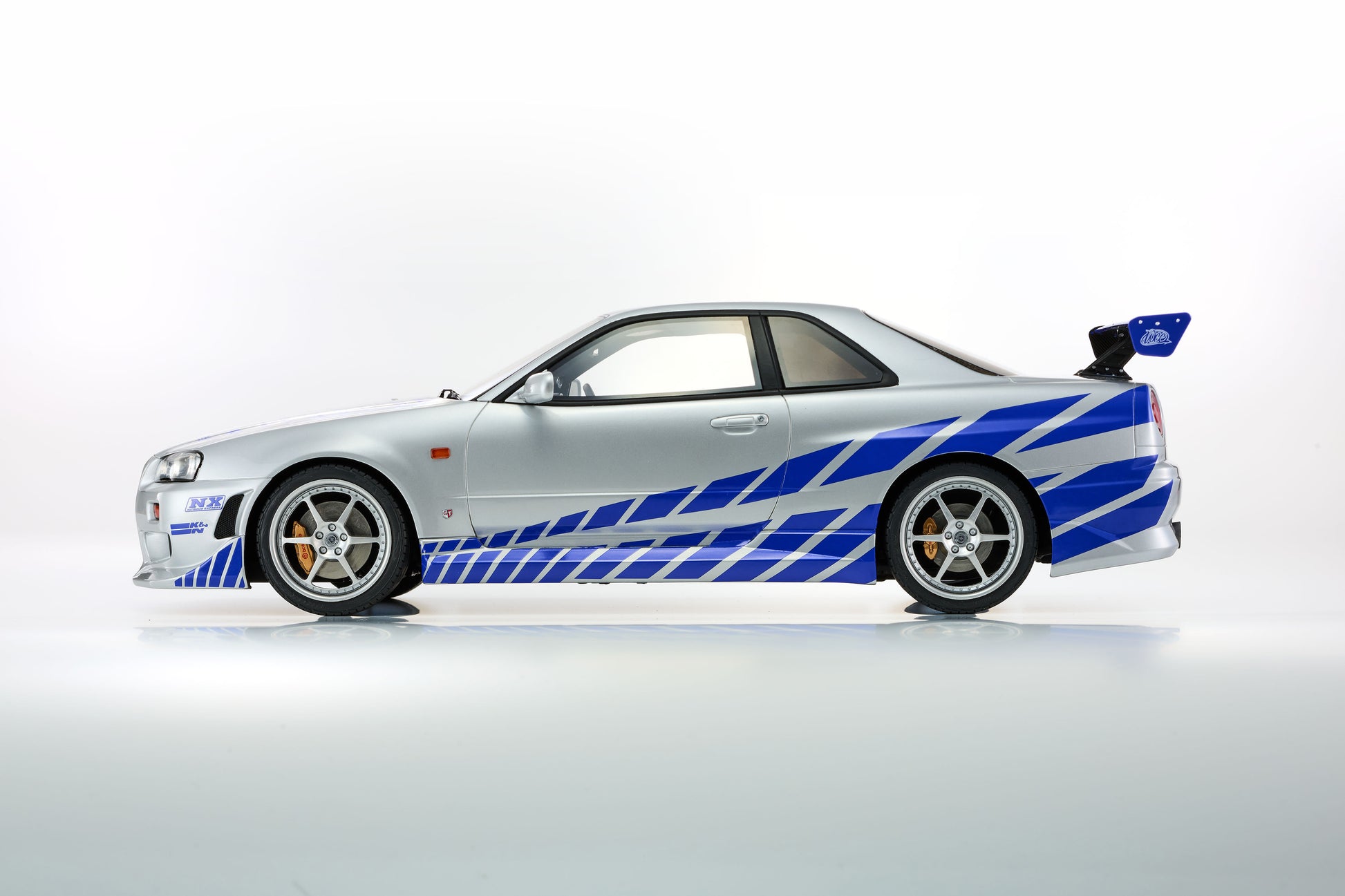 White sports car with blue and black stripes on a white background