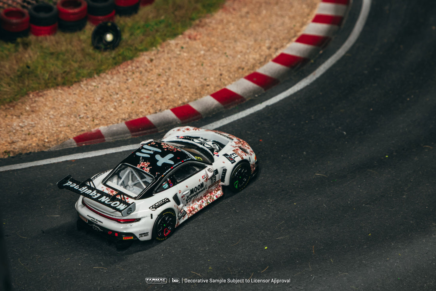 Race car on a track with a red and white curb