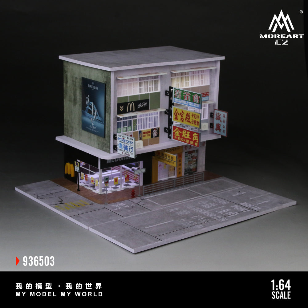 Model of a small store with various signs on a dark background, featuring the brand 'MoreArt'.