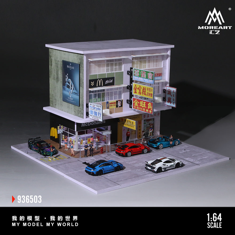 Model of a building with shops and cars on a dark background, featuring the brand 'MoreArt'.