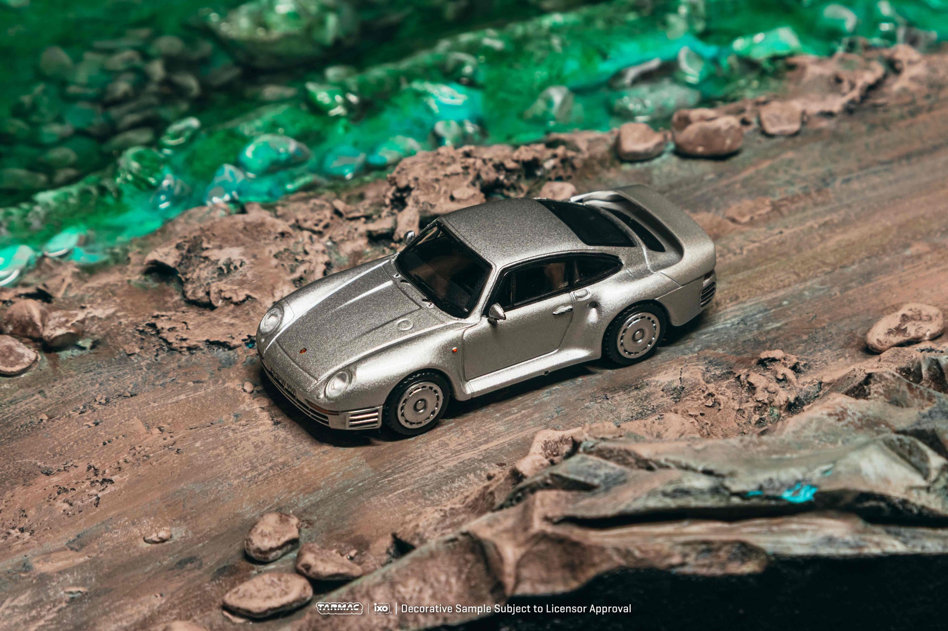 Model car on a rocky surface with a greenish background