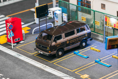 Model van on a miniature road with traffic lights and signs