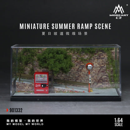 Miniature summer ramp scene model in a clear display case with a brick wall and red object.