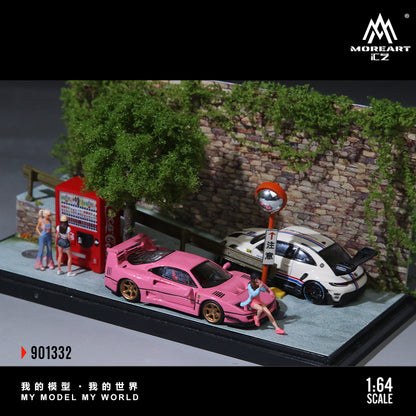 Model cars and people on a diorama with a Moreart CZ logo.