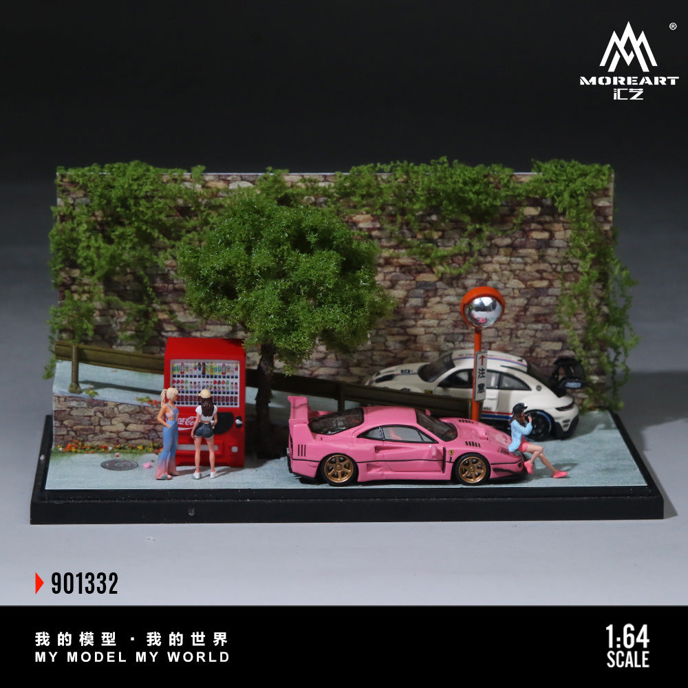 Model scene with pink car, people, and a vending machine against a stone wall and greenery.