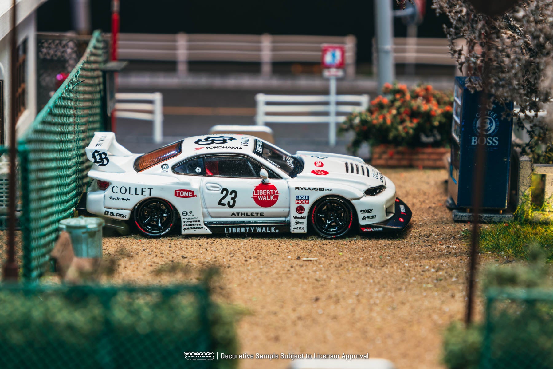 Model race car on a track with sponsor logos