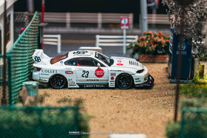 Model race car on a track with sponsor logos