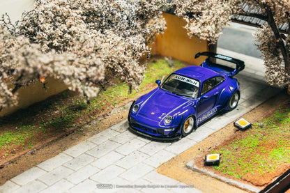 Blue model car with 'SUBARU' branding under cherry blossom trees.
