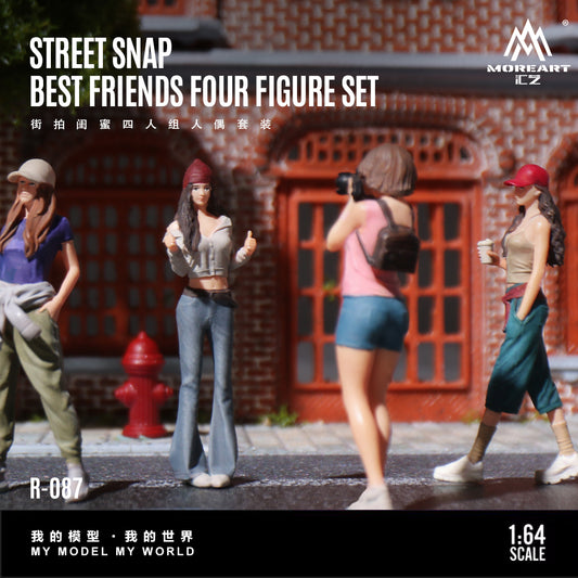 Four figurines in a street scene with a brick building and red fire hydrant, labeled 'Street Snap Best Friends Four Figure Set' by MoreArt.
