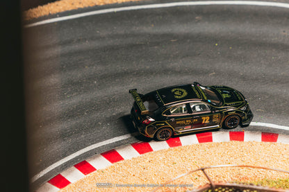 Model car on a track with a black and gold design