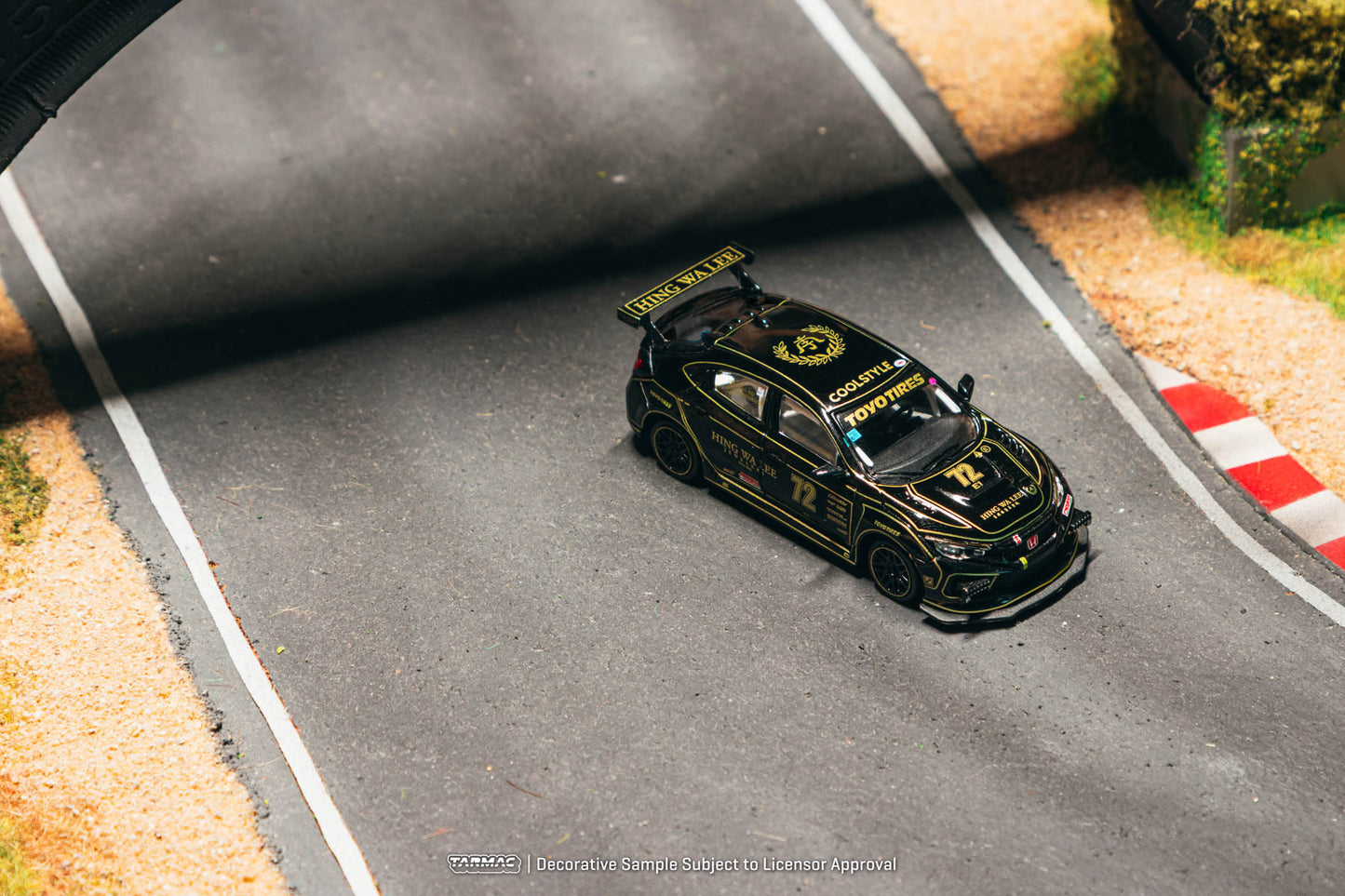 Black and yellow race car on a track with a blurred background