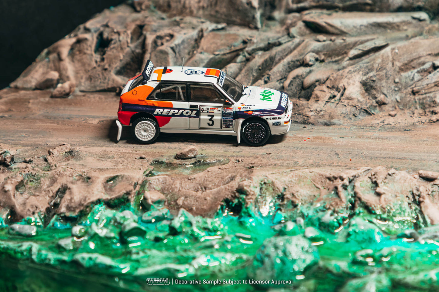 Model rally car on a rocky landscape