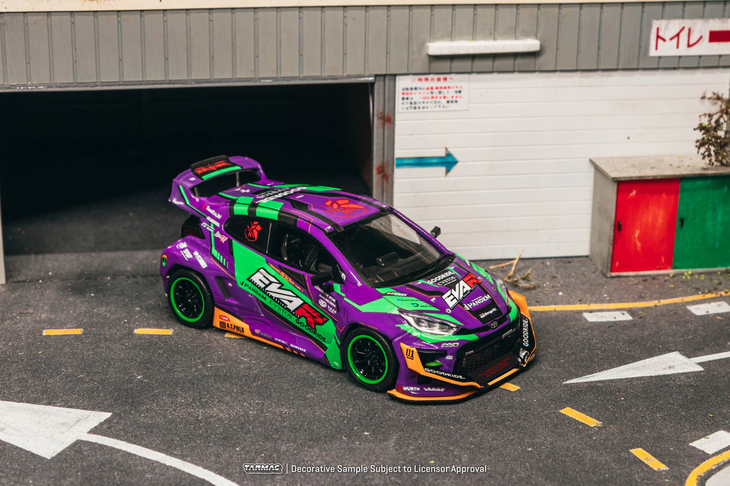 Colorful racing car parked in a garage with visible branding.