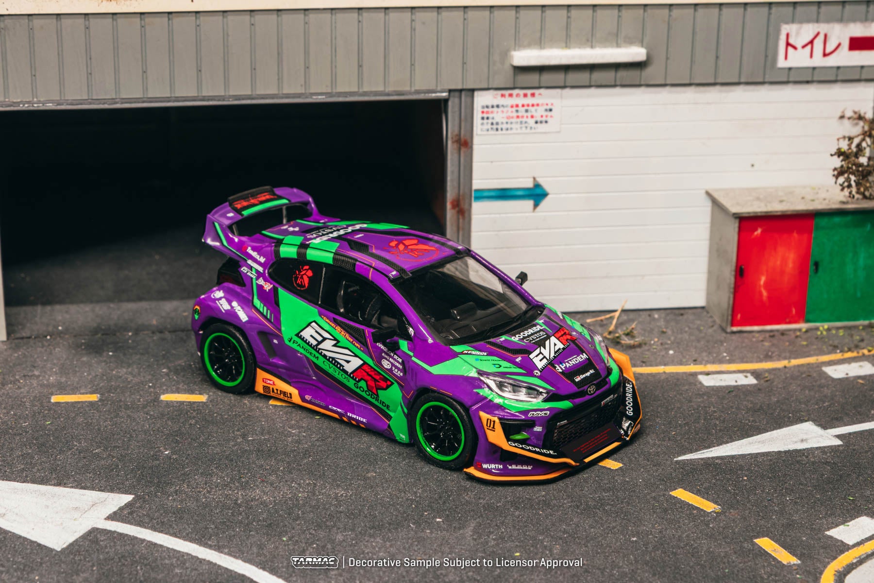 Colorful racing car parked in a garage with visible branding.