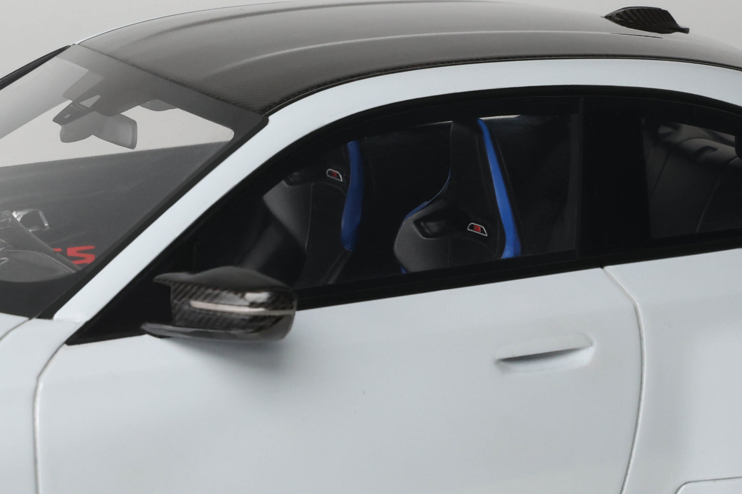 Close-up of a car's interior with a focus on the steering wheel and dashboard.
