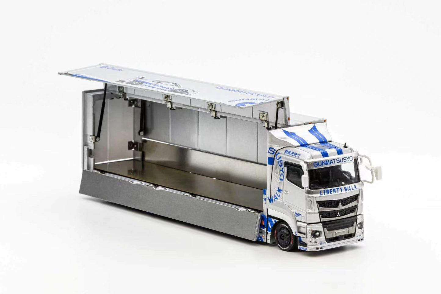 Model truck with open cargo area on a white background