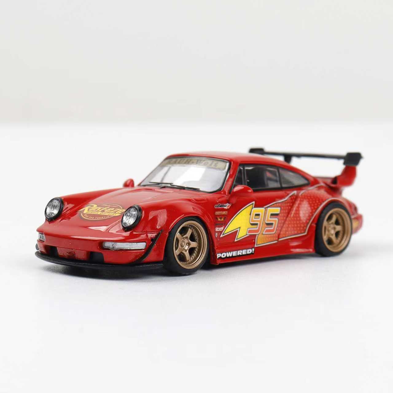 Red model car with yellow details on a white background