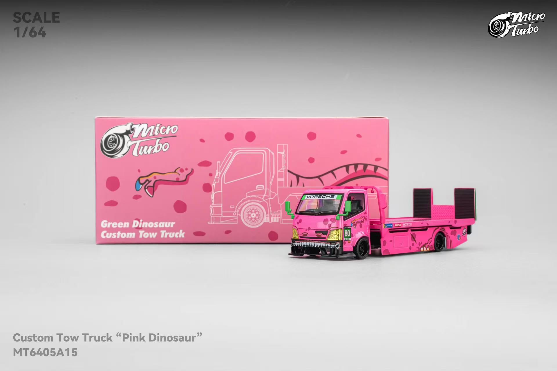 Model toy truck with 'Pink Dinosaur' design next to its packaging on a gray background