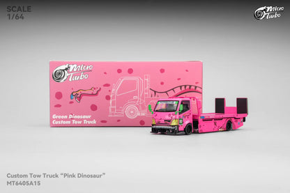 Model toy truck with 'Pink Dinosaur' design next to its packaging on a gray background