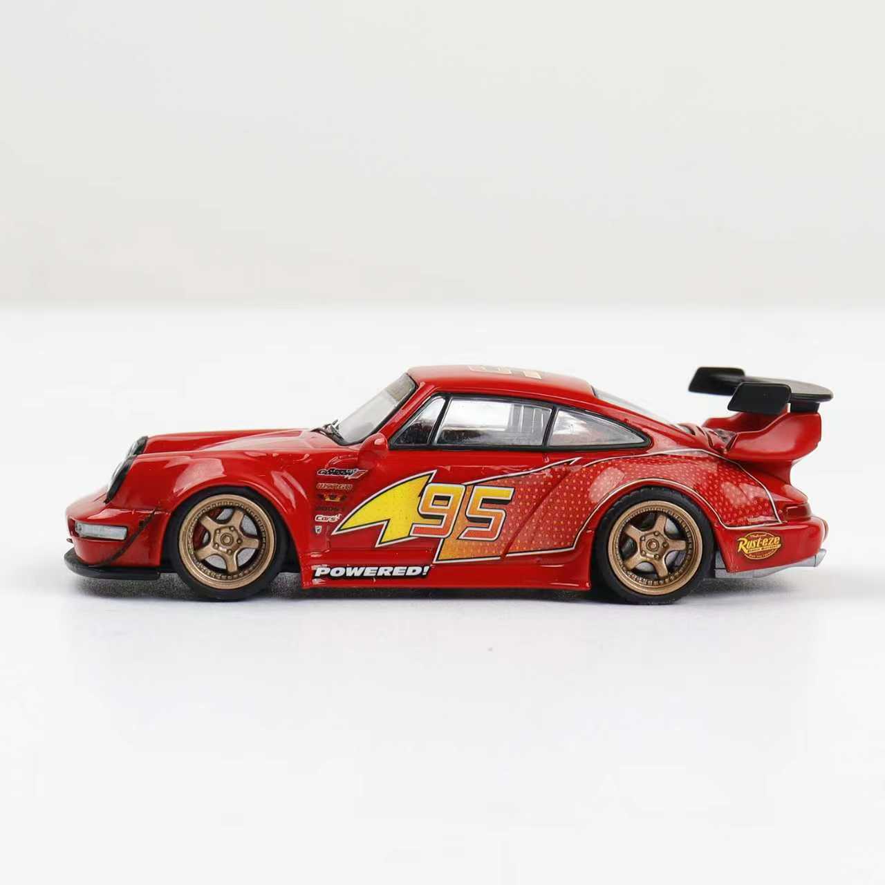 Red toy car with yellow number 495 on a white background