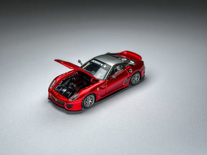 Red sports car model with open hood on a gray background