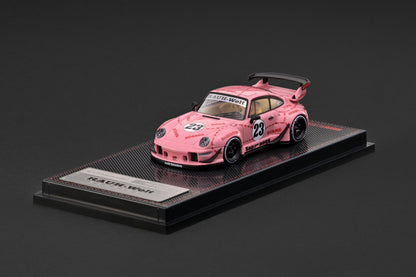 A pink model race car displayed on a black base with a plaque that reads 'RACE-WASH'. The car features number 23 decals and a black rear spoiler, photographed against a dark gray background.