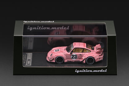 A pink model race car displayed inside a black presentation box with a clear front window. The car has the number 23 on the side and is branded with 'ignition model' on the box.