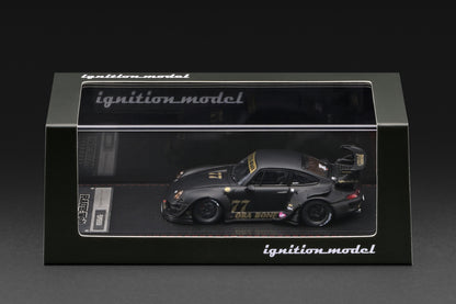 A 1:64 scale model car of the 1999 Toyota 993 RWD Nismo GT1, driven by Ori Bono, displayed inside its black Ignition Model packaging box against a dark background.