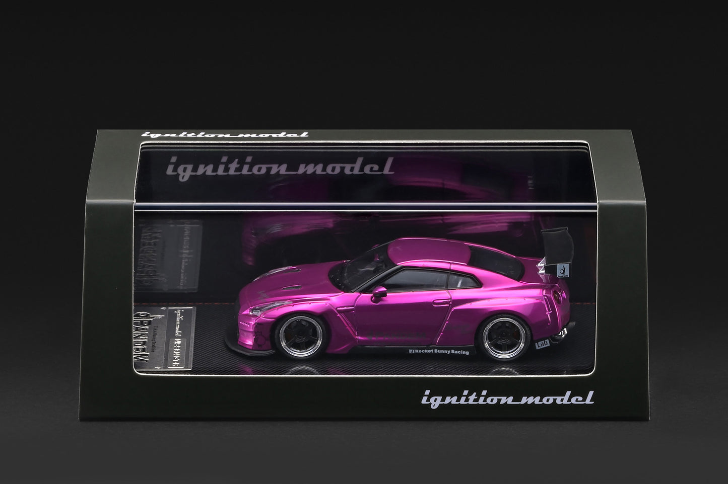 A pink Nissan GT-R model car displayed inside a black windowed box with the brand name 'ignition_model' visible on the packaging.