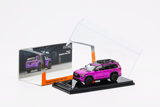 Pink toy car model in a transparent display case on a white background