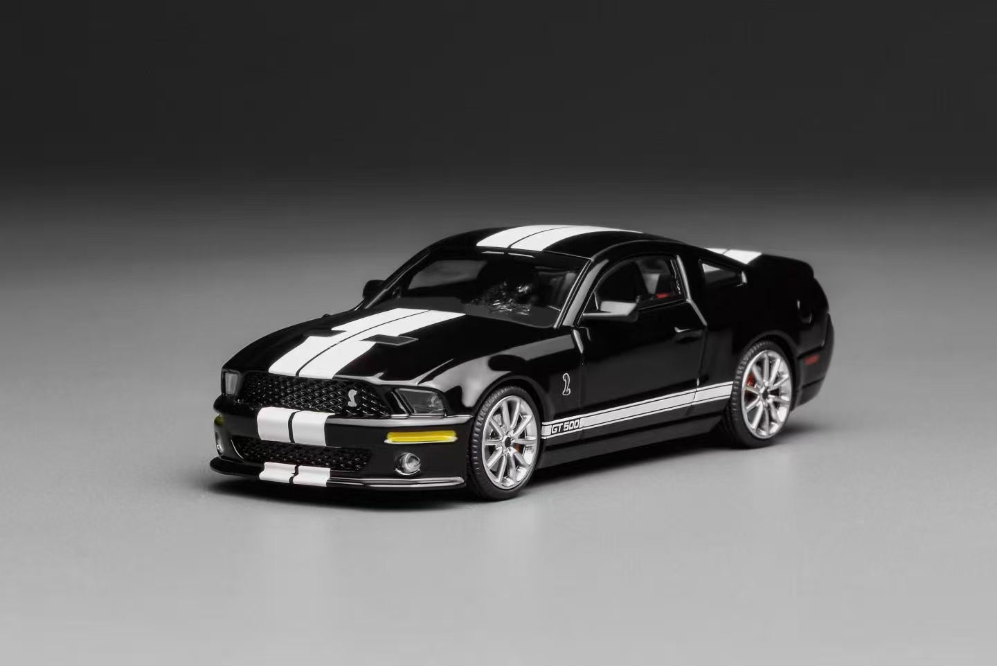 Black and white model car on a gray background