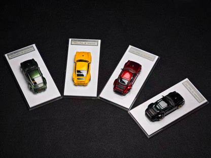 Four miniature cars on display with white cards on a dark background