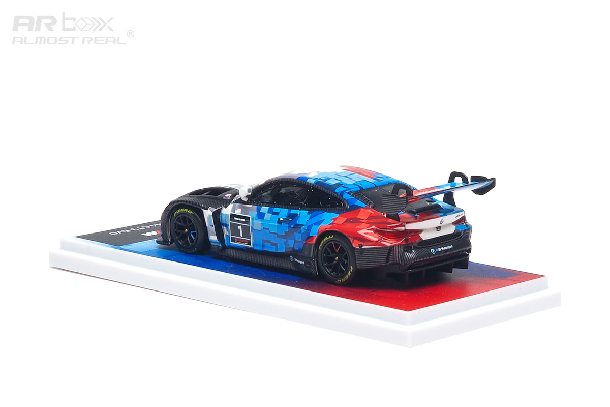 AR Box 1:64 BMW M4 GT3 EVO #1 BMW M Motorsport Racing Livery Diecast Model Car Rear Three Quarter View with Blue Red White Camouflage Graphics, Black Racing Wheels, Large Rear Wing and Display Base