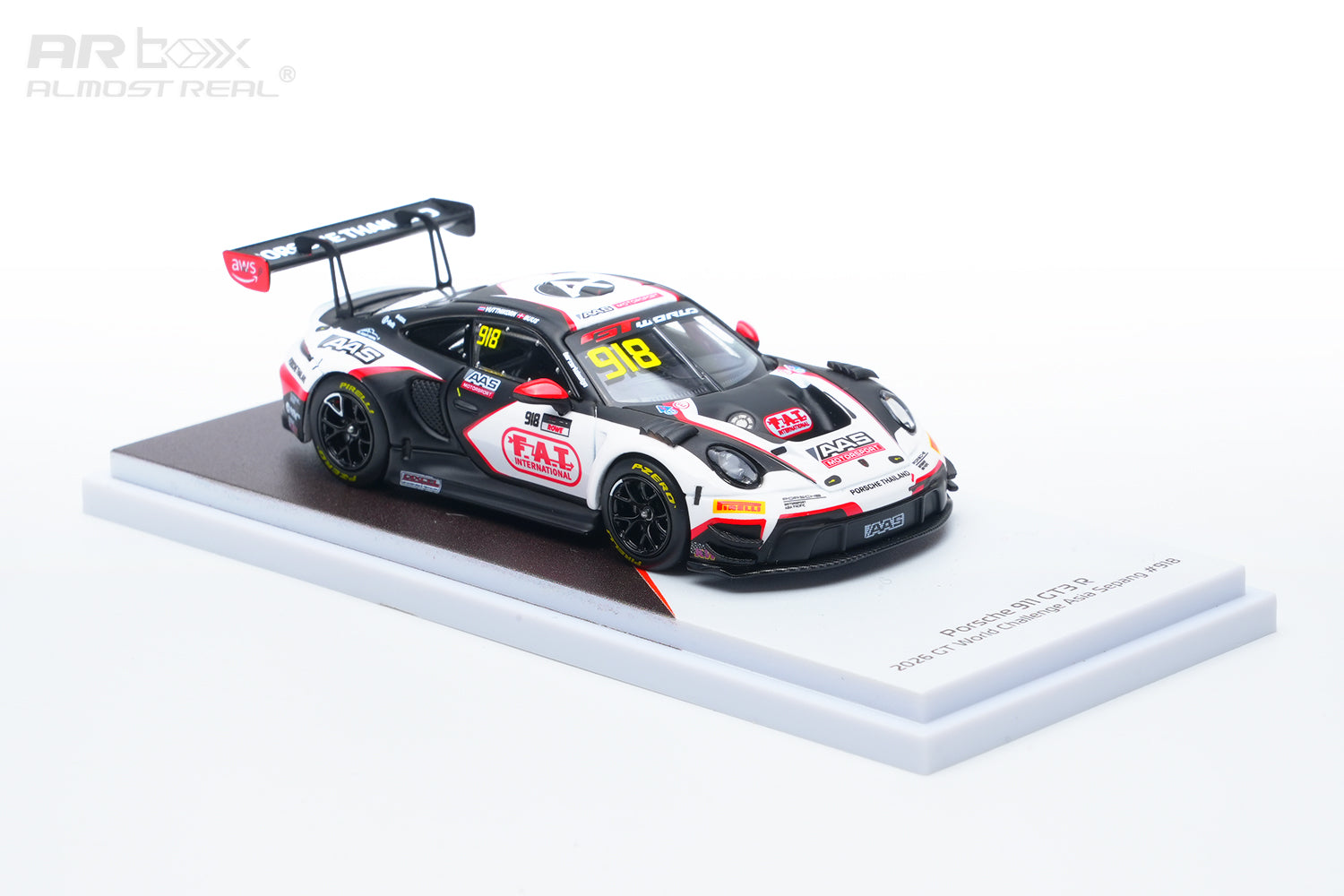 A 1:64 scale model of a Porsche 911 GT3 race car, specifically the 2024 Racing Team livery, displayed on a white and brown base against a white background.