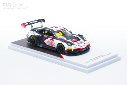 A 1:64 scale model of a Porsche 911 GT3 race car, specifically the 2024 Racing Team livery, displayed on a white and brown base against a white background.