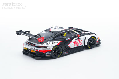 A 1:64 scale model Porsche 911 GT3 race car with a black, white, and red livery, featuring sponsor decals like PIA and FIA, photographed on a seamless white background.