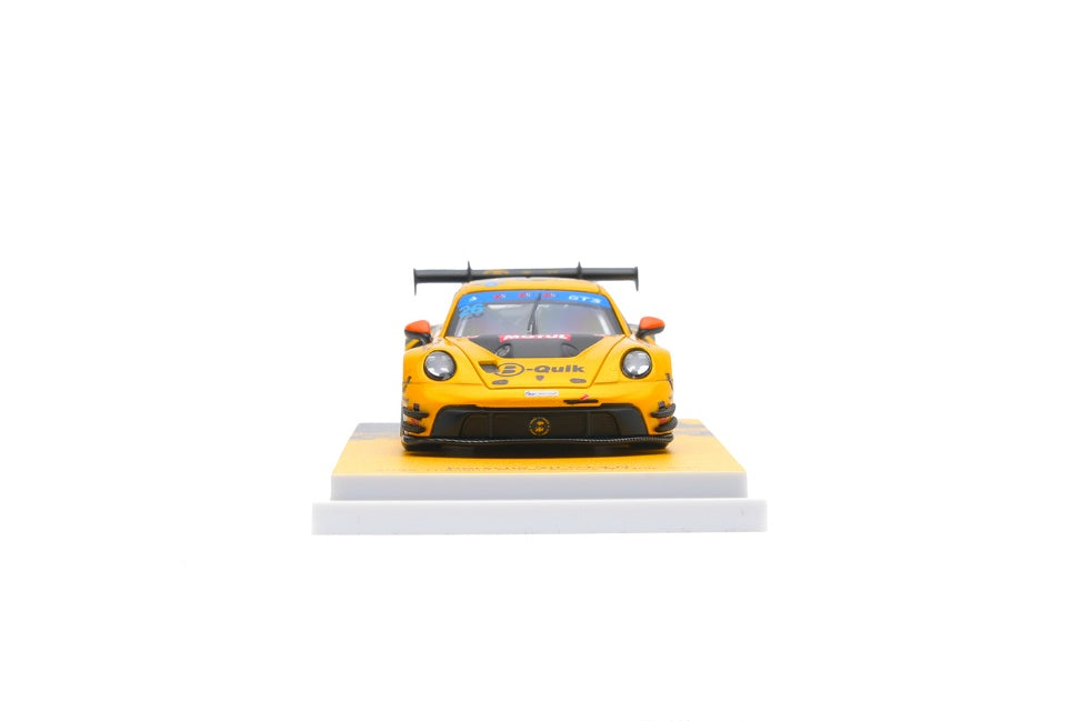 Yellow Porsche 911 sports car model on a white platform with a white background