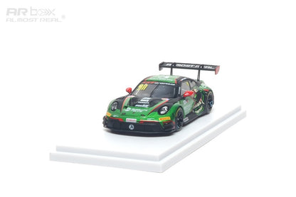 Model racing car on a white platform with a white background