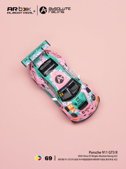 A pink and teal die-cast model race car with cherry blossom graphics, shown from an overhead angle on a solid pink background. The top of the image features the ARBOX and Absolute Racing logos, and the bottom displays model number 69 and Porsche 911 GT3 R text.