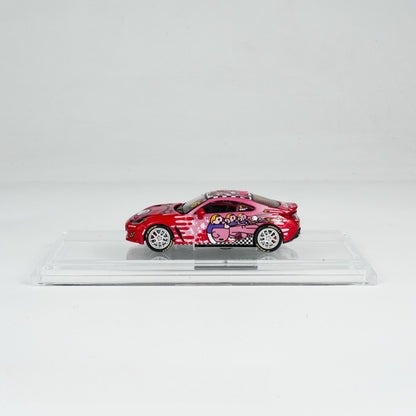 A red toy car with anime-themed graphics displayed in a clear case. The box features a checkered design and cartoon characters, conveying a fun, playful tone.
